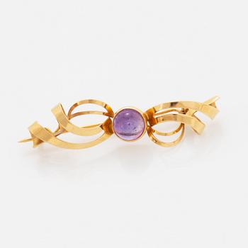 A pair of earrings and a brooch.