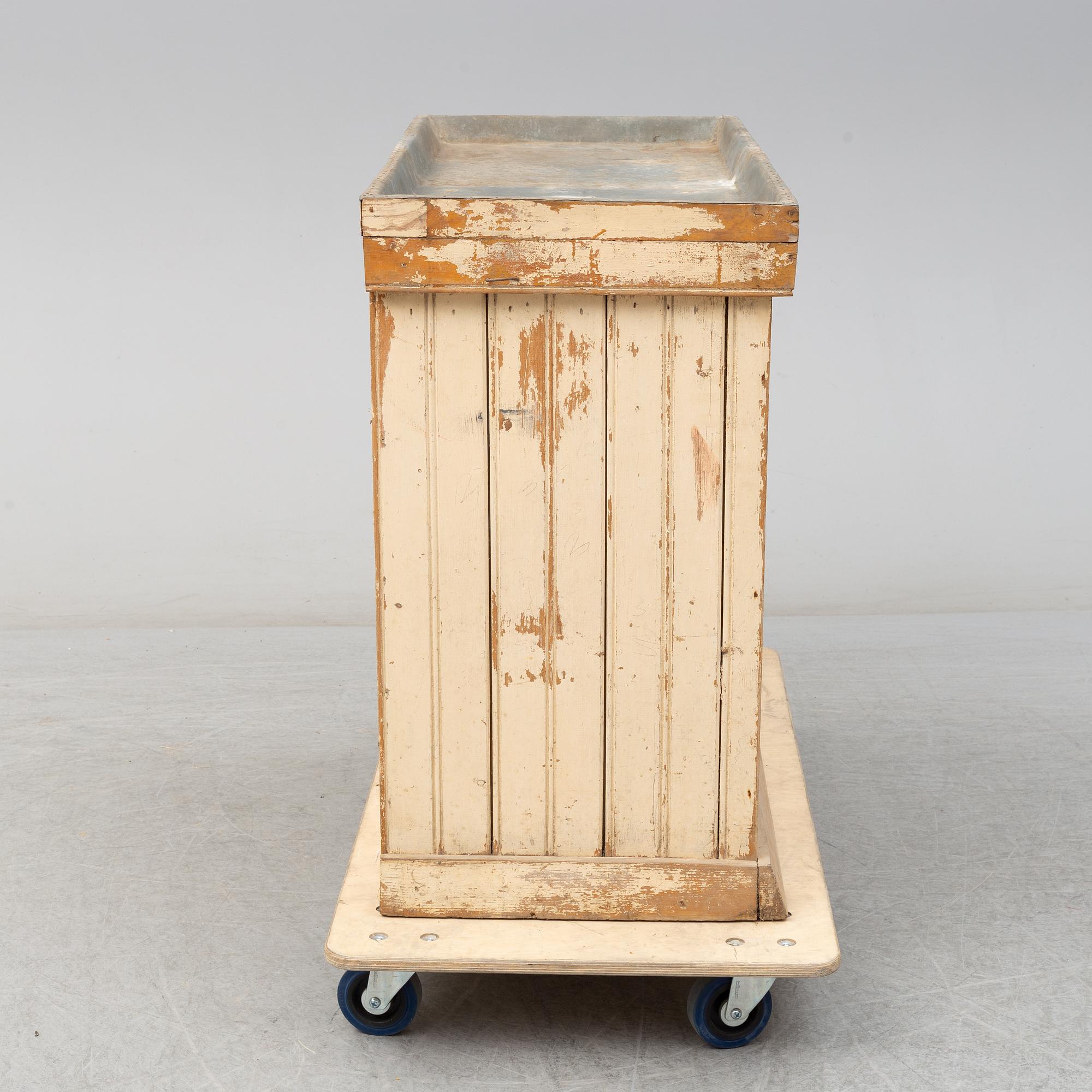 A late 19th Century cabinet with zink top.