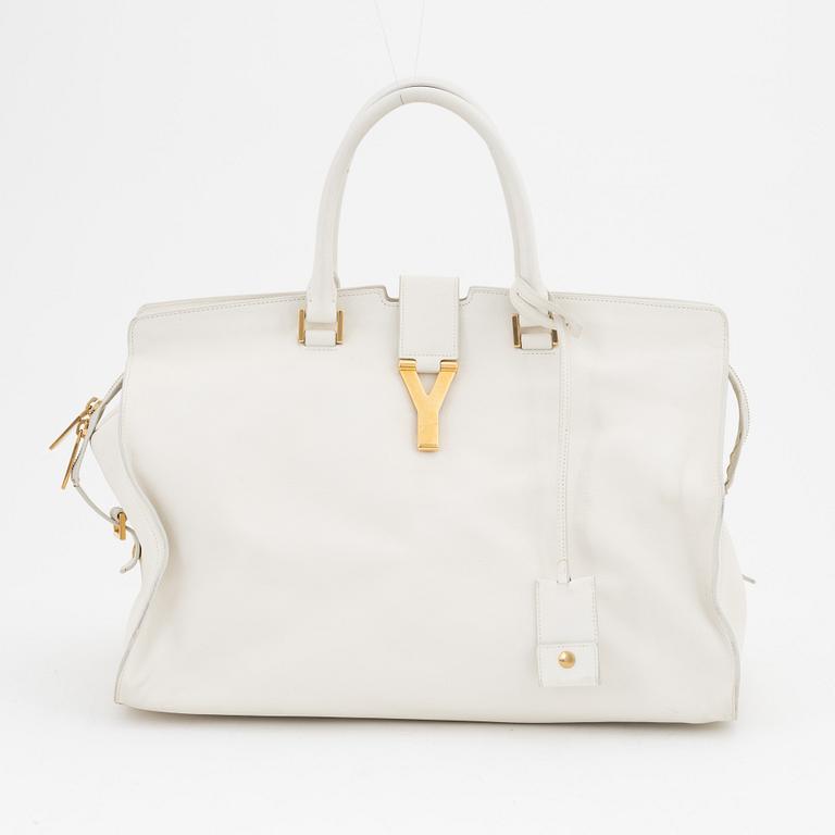 Yves Saint Laurent, a white leather handbag.