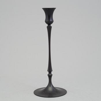 A bronze "Egg and dart candlestick" by E.R. Butler, Ted Muehling.