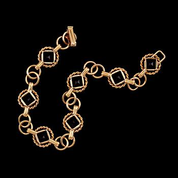 ARMBAND, 18 k guld och sannolikt ametister, 1952. Vikt ca 16 g.