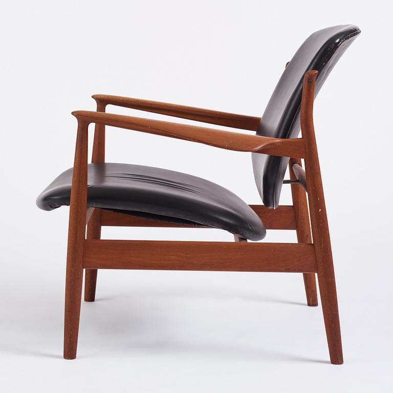 Finn Juhl, a teak and black leather 'model 136' easy chair, France & Daverkosen, Denmark 1950-60s.