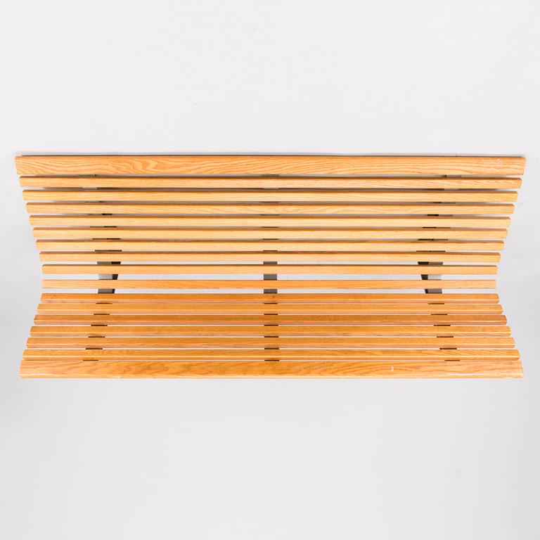 OLLE ANDERSON, A Swedish wall mounted wooden bench manufactured by Nola in the 2000s.