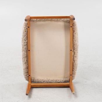 A sheepskin upholstered oak stool, second part of the 20th Century.