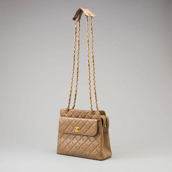 A beige hanbag by Chanel 1989-1991.