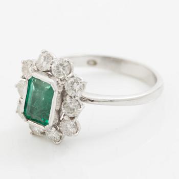 Ring 18K white gold set with a step-cut emerald and round brilliant-cut diamonds.