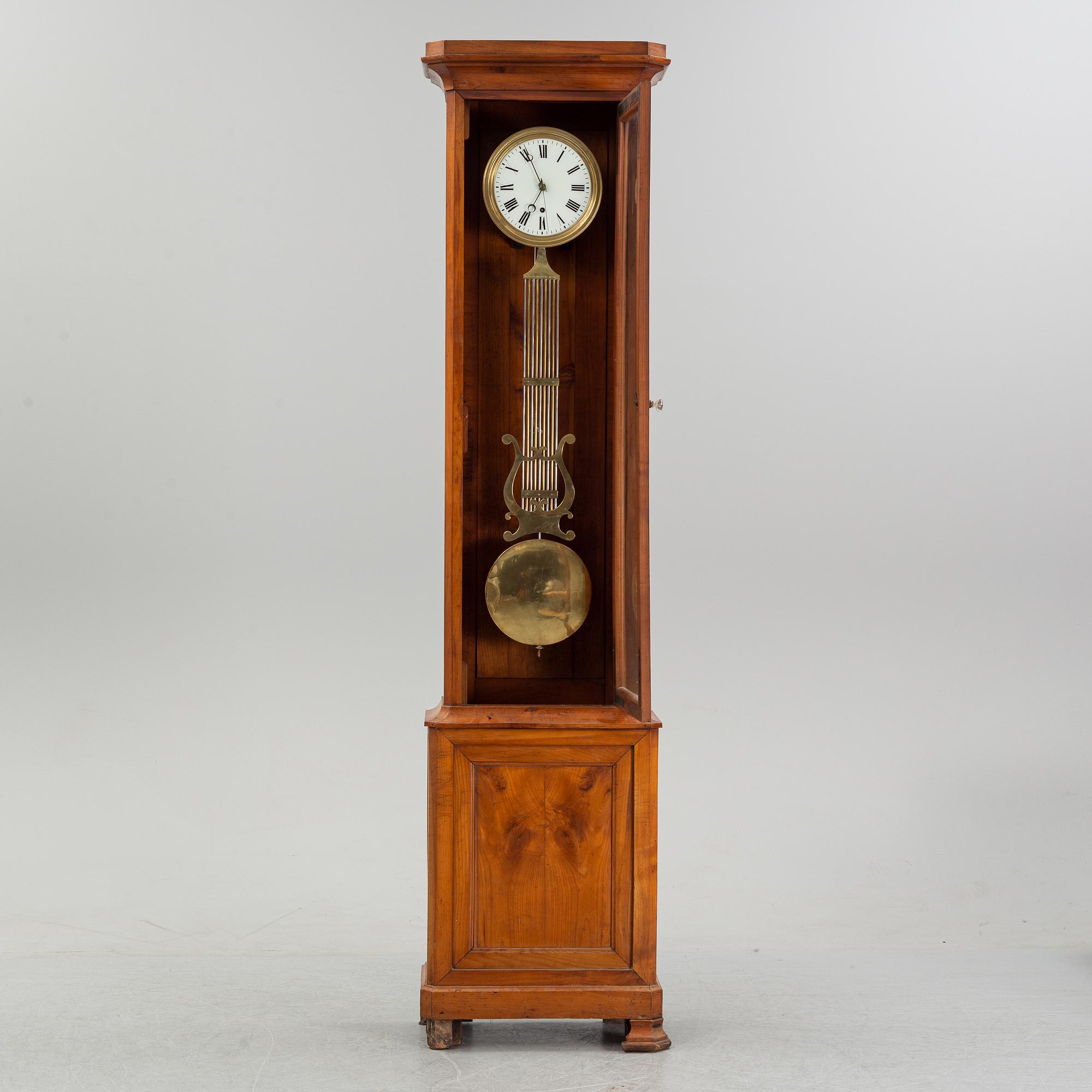 A walnut long case clock, from around the year 1900.