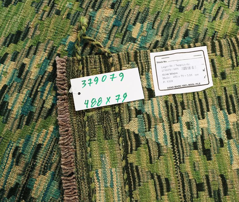 An Afghan kilim runner, c. 488 x 79 cm.