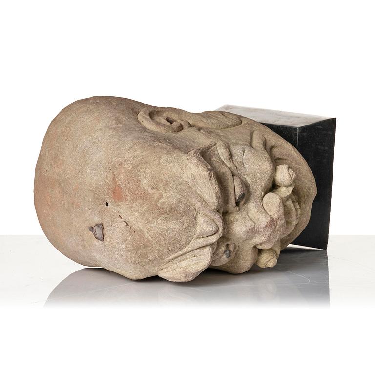 A sanstone sculpture of a Luohan, Yuanstyle.