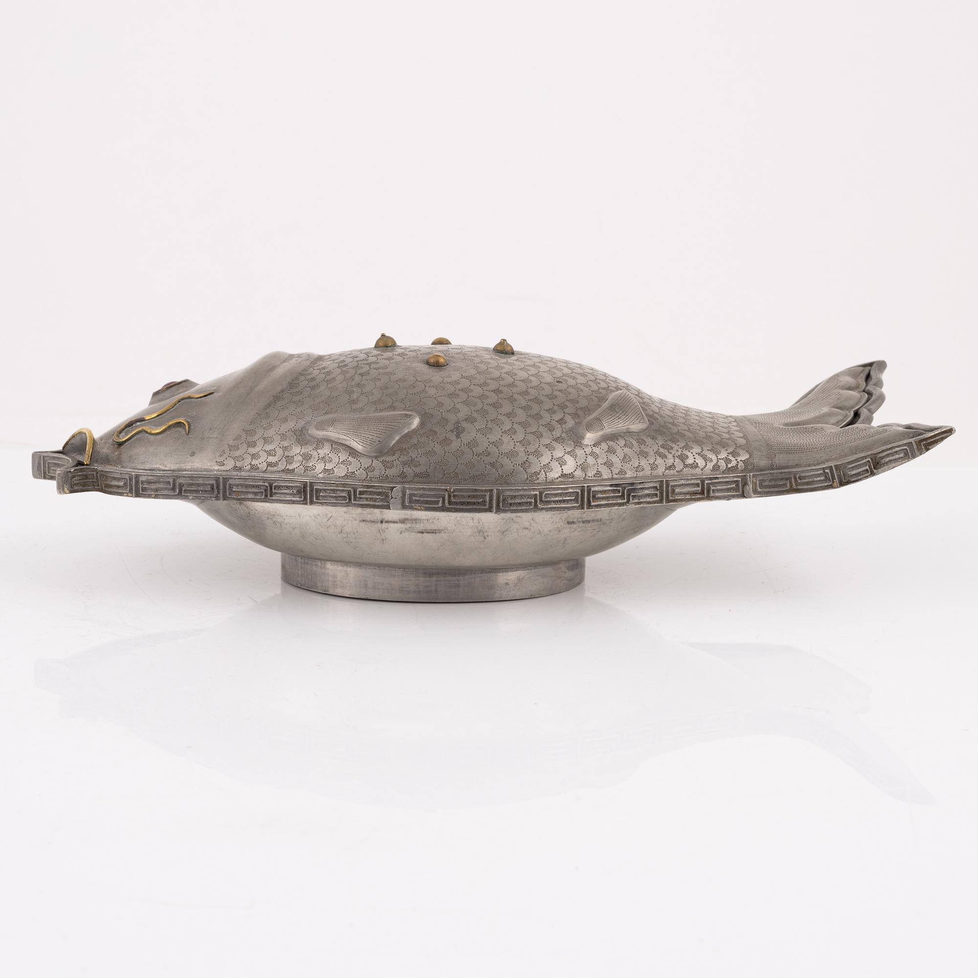 A pewter jelly mould with lid.