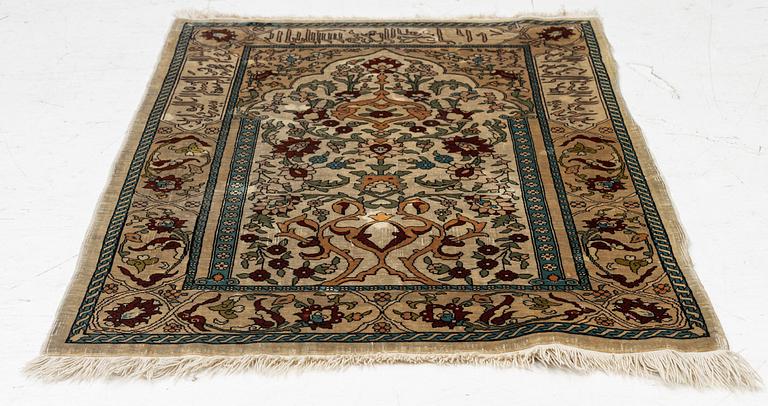 A Hereke silk rug, c. 73 x 52 cm.