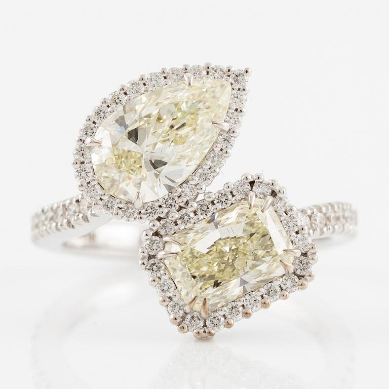 Crossover ring, 18K white gold set with pear-shaped and emerald-cut diamonds. Accompanied by GIA report.