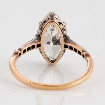 A 14K gold and silver ring set with a navette-cut diamond with a total weight of ca 2.75 cts quality ca K vs.