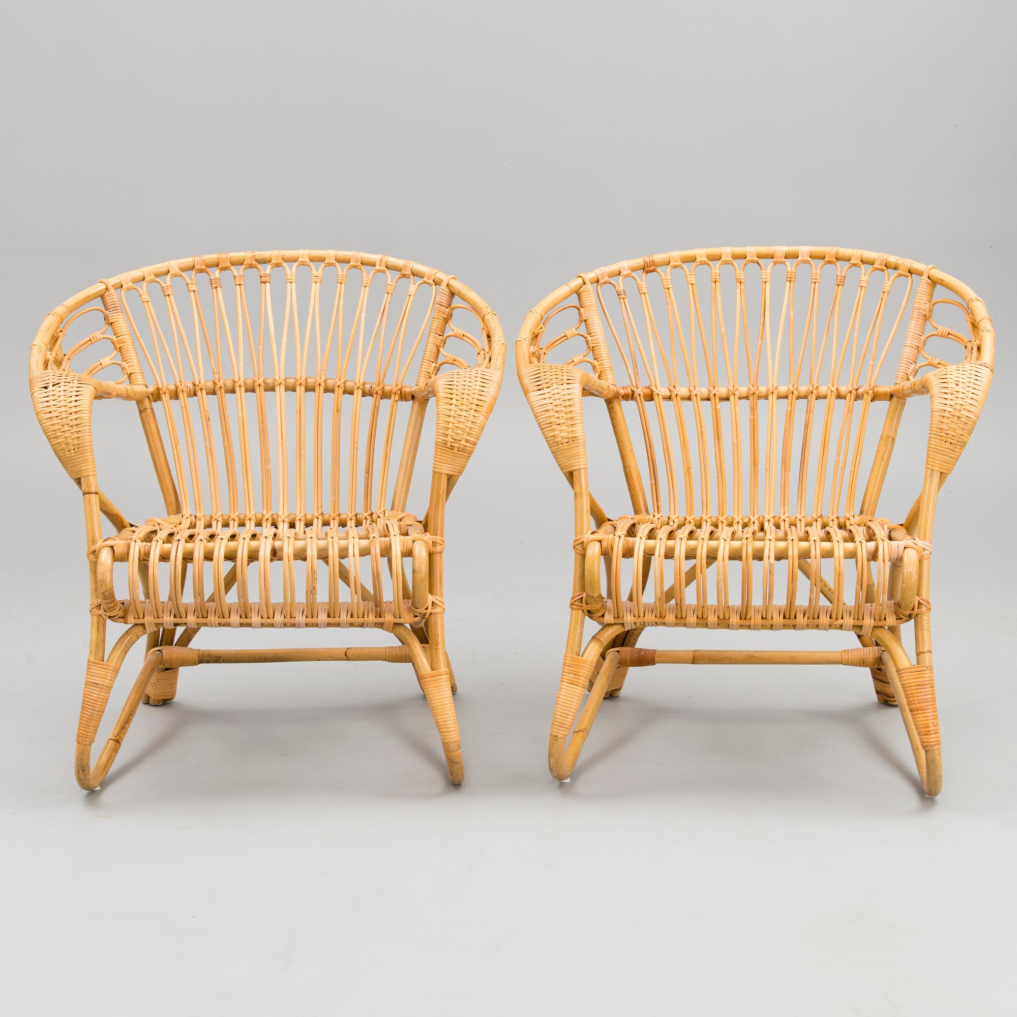 A pair of rattan arm chairs from the latter half of the 20th Century.
