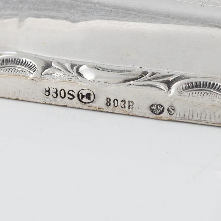 A Swedish Silver Ladle, mark of Adolf Öström, Piteå 1887 and a pair of Silver Candlesticks.