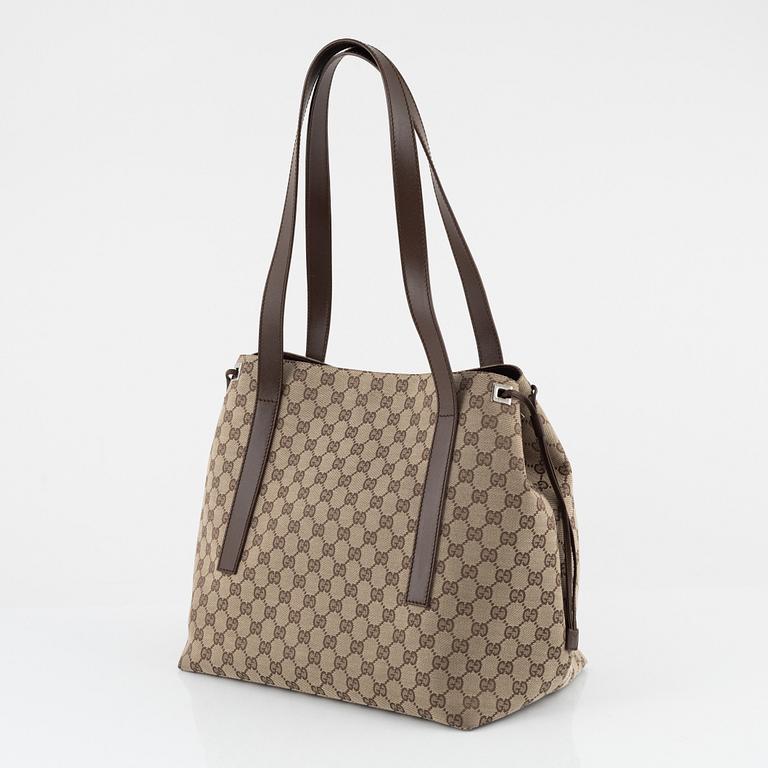 Gucci, a canvas handbag.