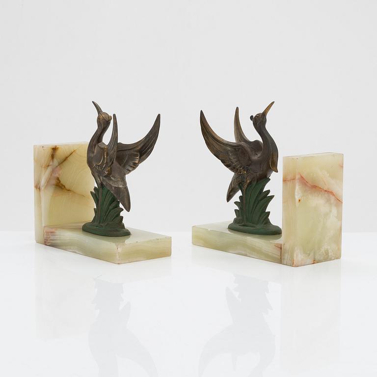 A pair of alabaster and  patinated metal Art Deco bookends from the first half of the 20th Century.