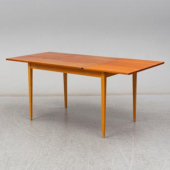 A 1960s teak veneered dining table.