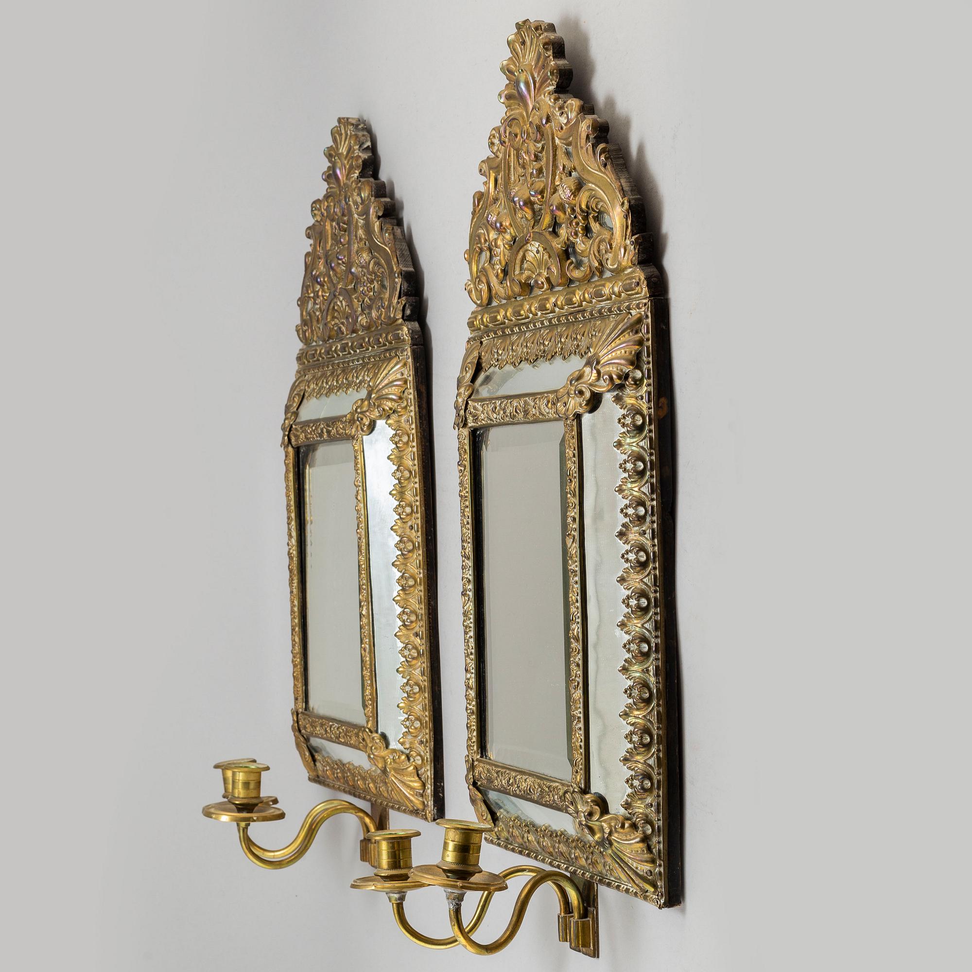 An early 20th Century pair of baroque style mirror sconses.