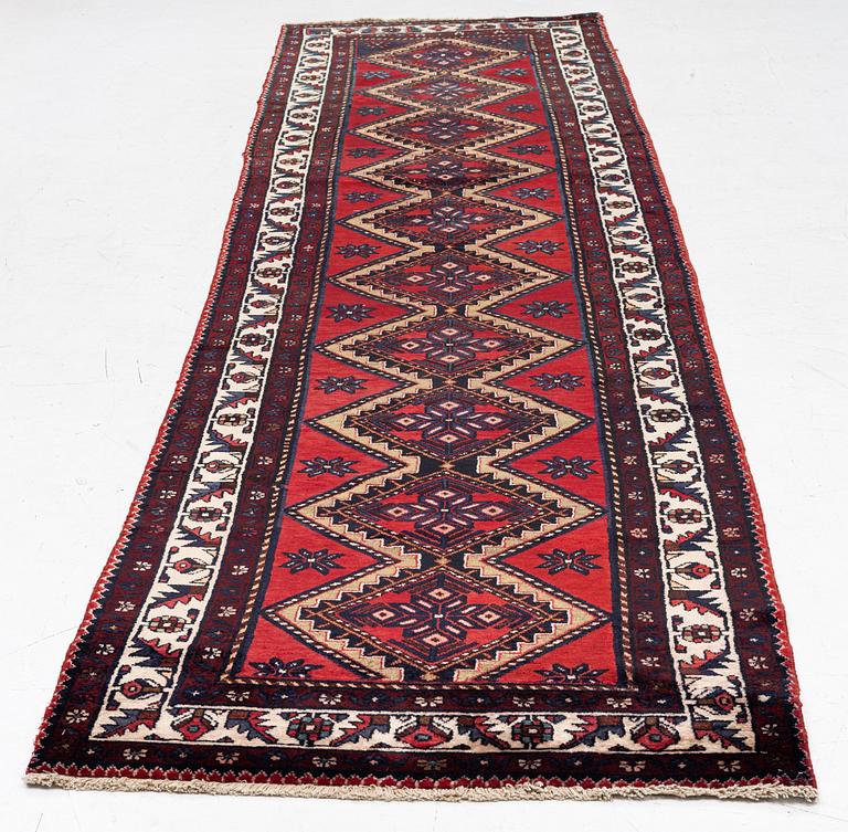 An oriental runner, c. 395 x 100 cm.