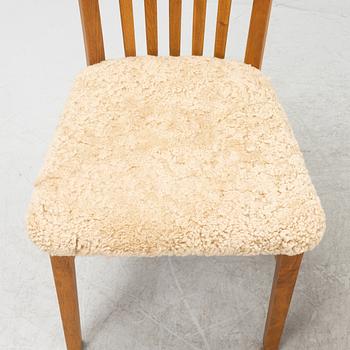 A set of four oak chairs with new  sheepskin upholstery.