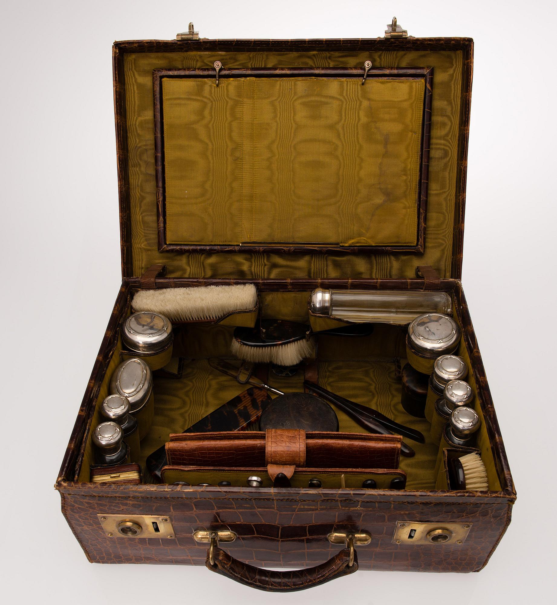 A TRAVEL TOILET CASE, leather, German 1910-20s, boxes with silver lid.