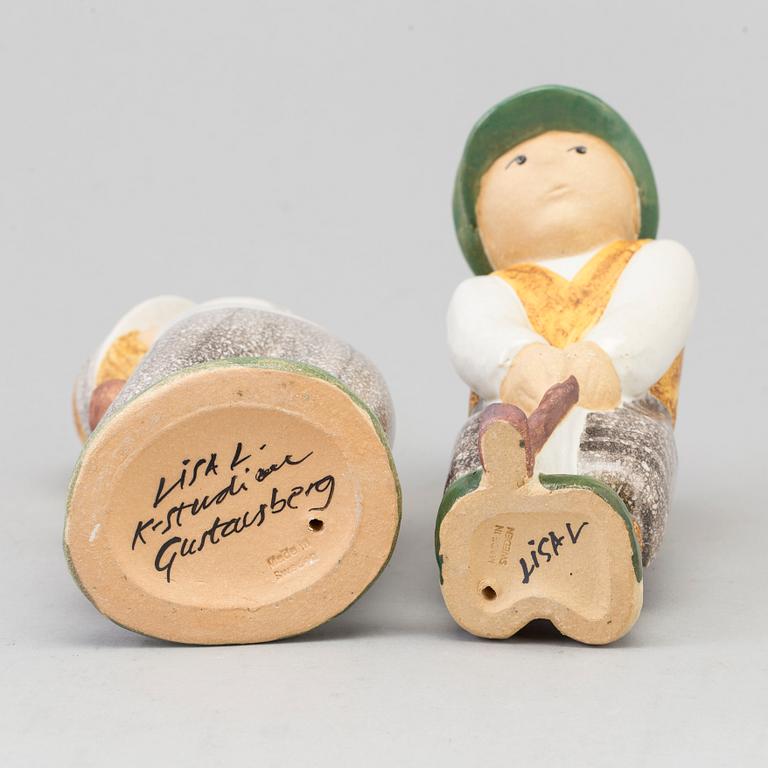 LISA LARSON, a pair of golfer stoneware figurines from Gustavsberg.