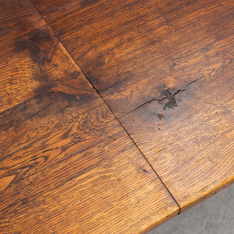 An oak dining table, Baroque early 18th century and Baroque style 19th/20th century.
