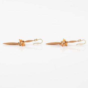 A pair of earrings in 14K and 9K gold with coral and quartz, by Ted Muehling purchased at Svenskt Tenn.