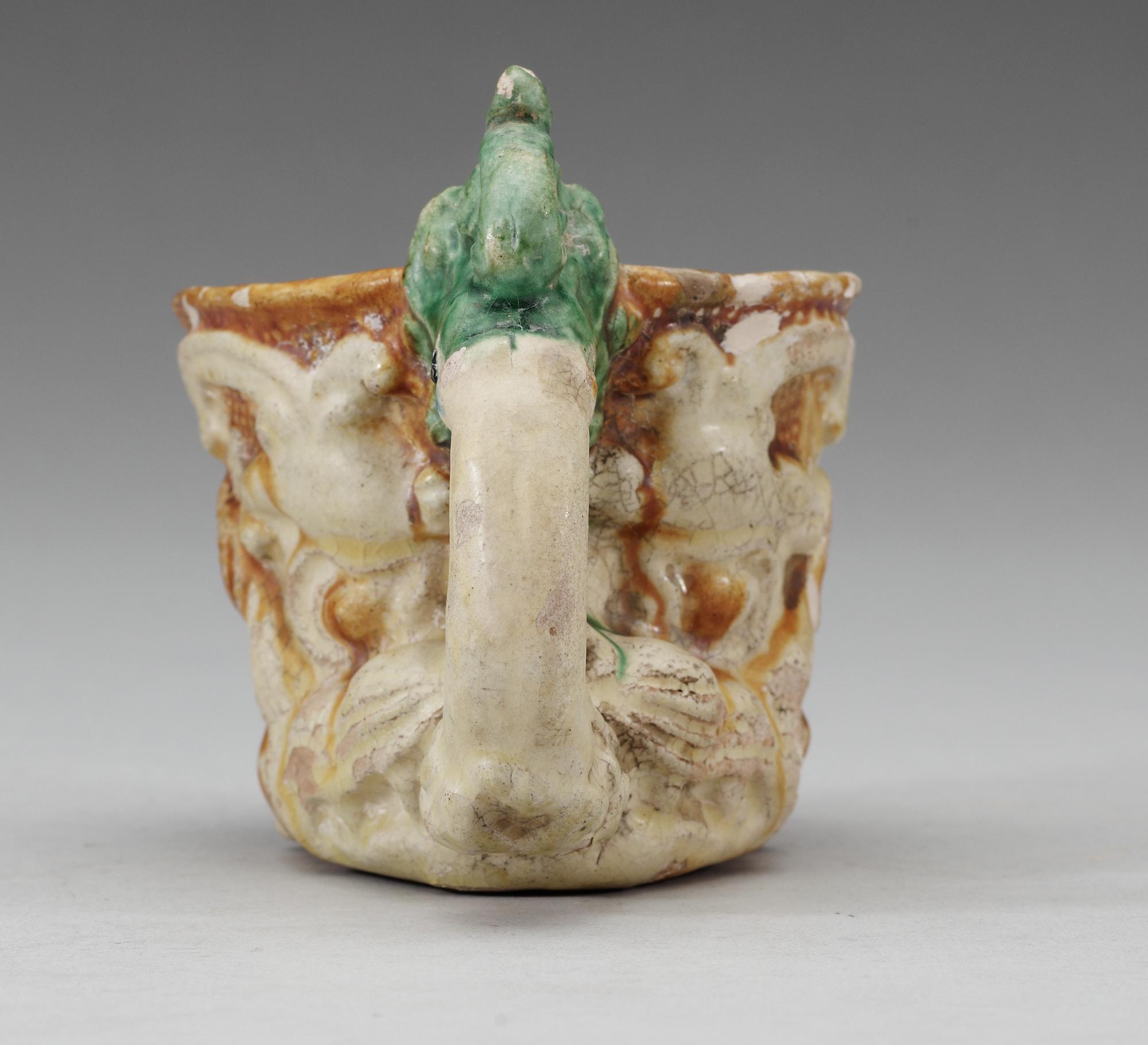 A green white and yellow glazed rhyton ewer, Tang dynasty (618-907).