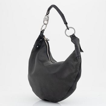 Gucci, a leather bag.