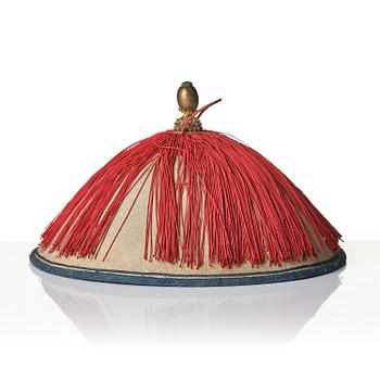 Two boxes with a mandarin's summer hat and black satin autumn hat and feather with six mandarin hat insignias.