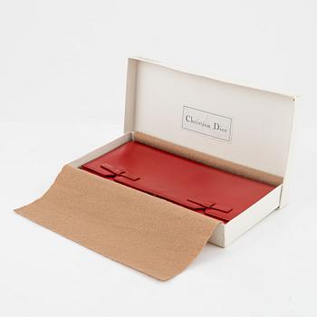 Christian Dior, a red box calf leather clutch.