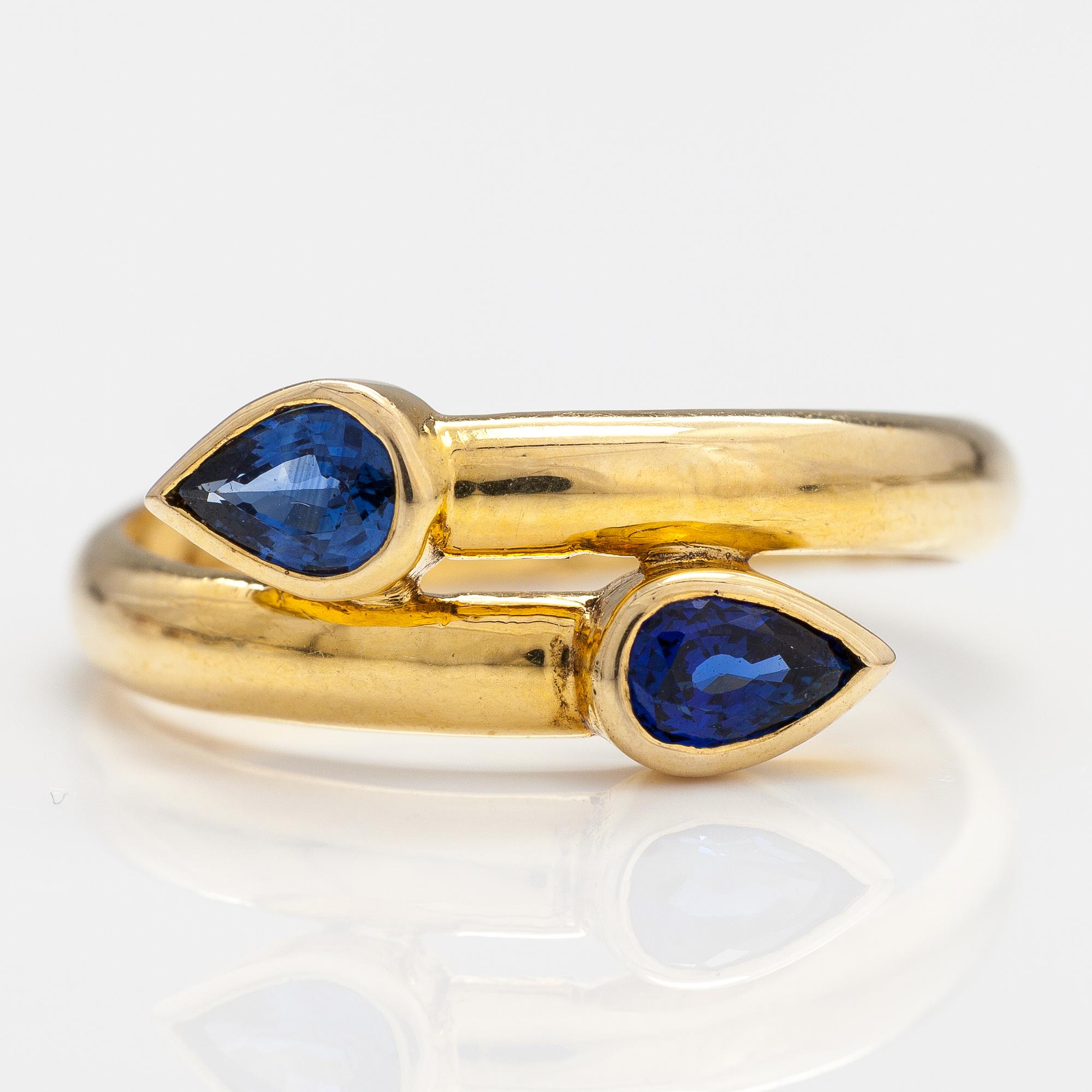 An 14-18K gold ring with two sapphires.
