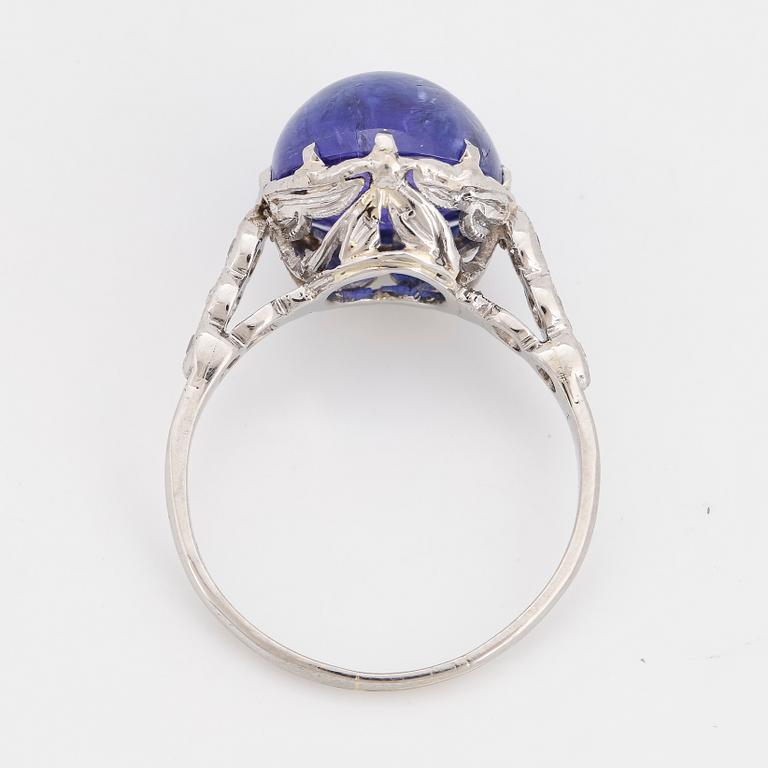 Cabochon-cut tanzanite and brilliant-cut diamond ring.