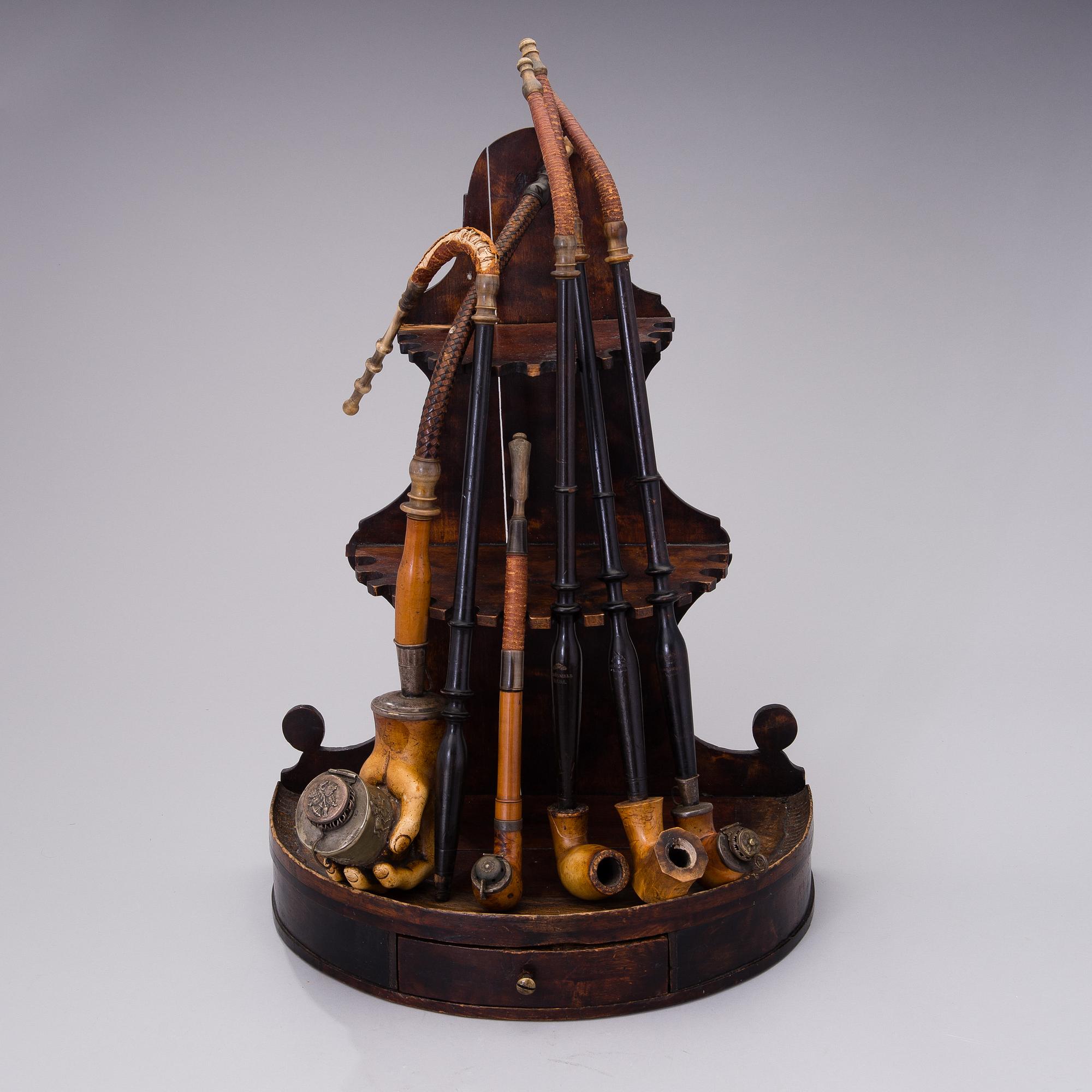 19th century pipes on a wooden pipe rack.