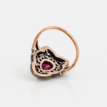 A ring set with a pear-shaped, synthetic ruby and rose-cut diamonds.