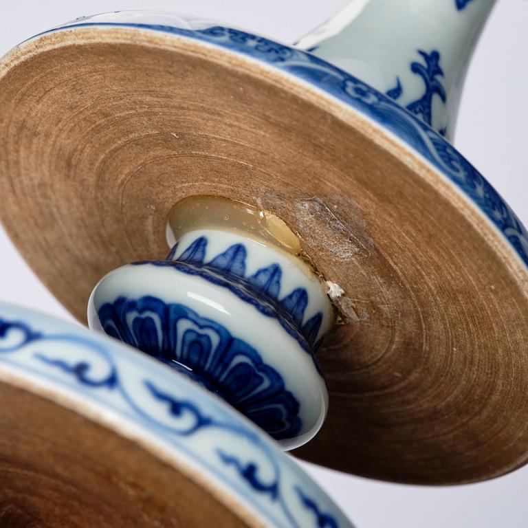 A pair of blue and white pricket candle sticks, with a poem, Qing dynasty with a Qianlong mark and of the period.