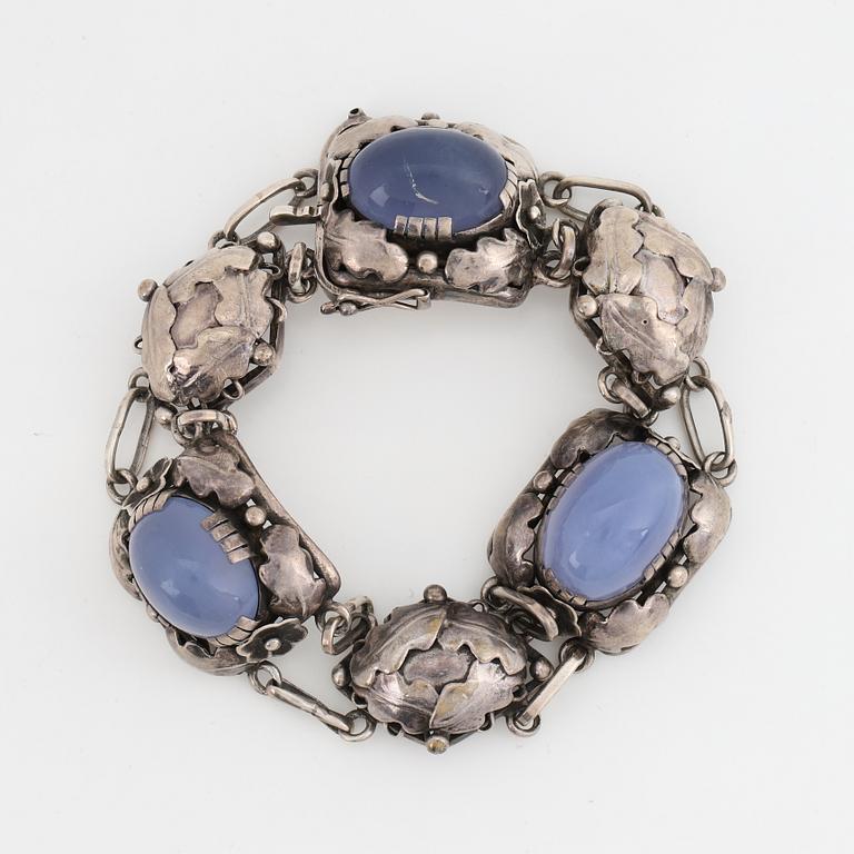 Bracelet, silver and cabochonslipade blue chalcedony, Gussi Smycken AB, Malmö, 1951.