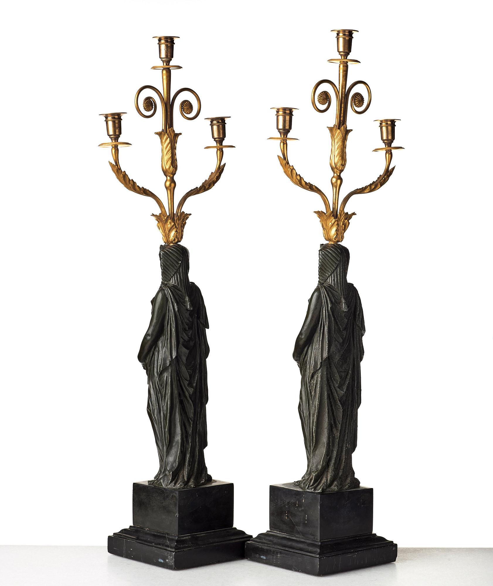 A pair of French Empire early 19th century three-light candelabra.