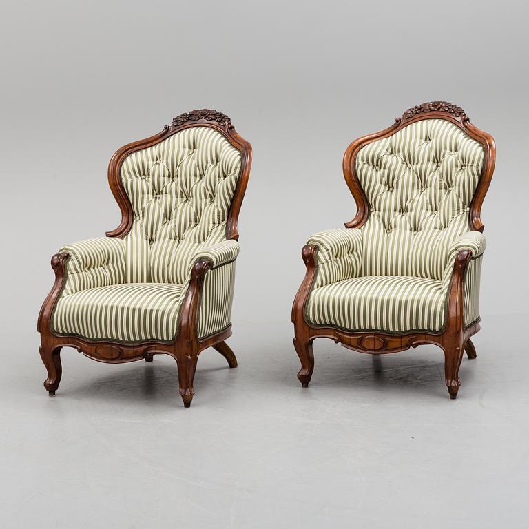 A pair of late 19th century rococo style easy chairs.