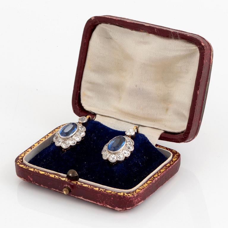 A pair of 14K gold and platinum earings set with faceted synthetic sapphires and old-cut diamonds.