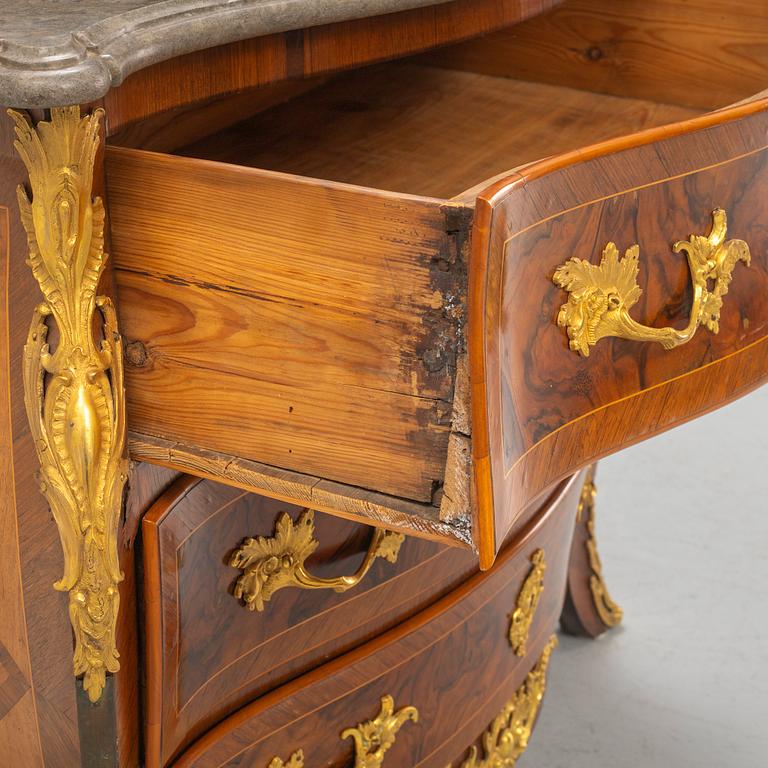 A Swedish rococo parquetry and gilt-bronze mounted commode in the manner of C. W. Hein, later part of the 18th century.