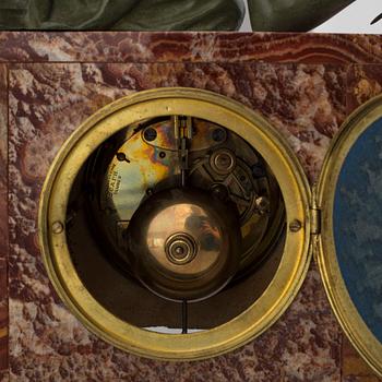 An early 20th century mantle clock with a bronze sculpture signed M. Charny.