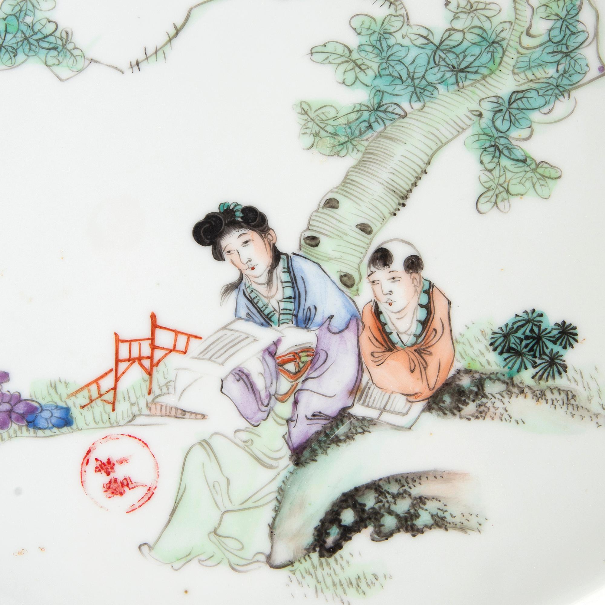 A set of two Chinese porcelain trays decorated with elegant ladies and children, 20th century.