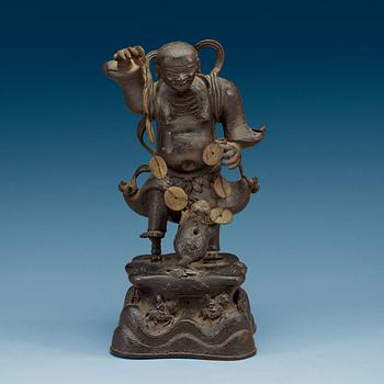 1512. A bronze figure of Liu Hai with money and a three legged toad, Qing dynasty (1644-1912).