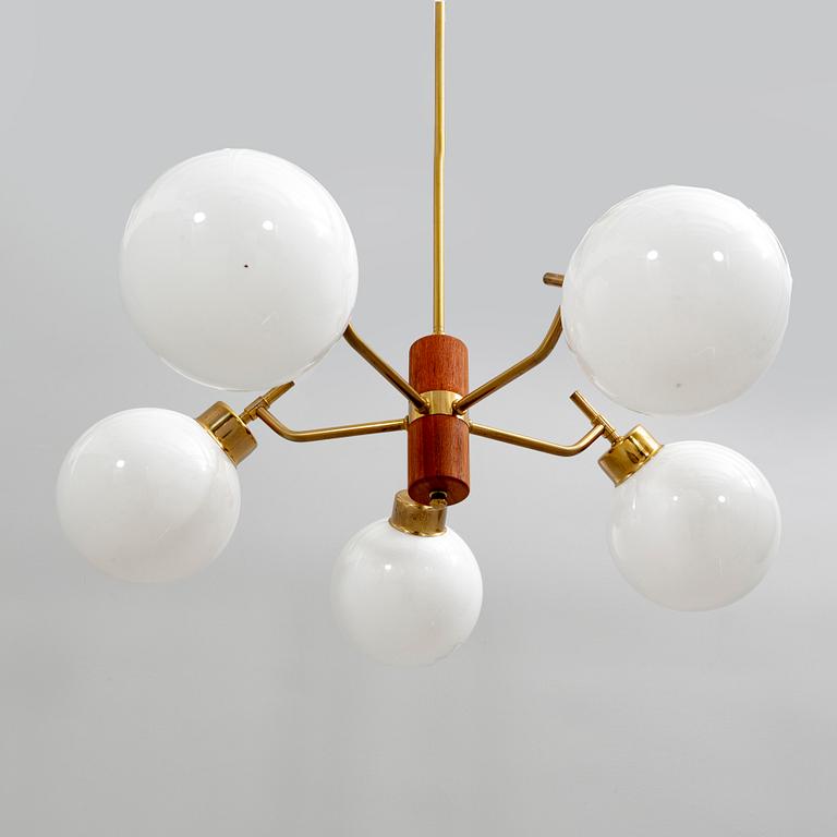 A 1950s brass and wood ceiling pendant.