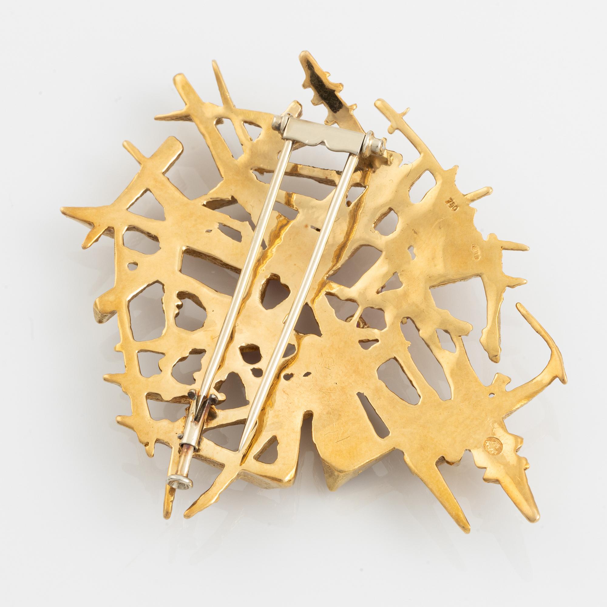 An 18K gold brooch set with faceted rubies.