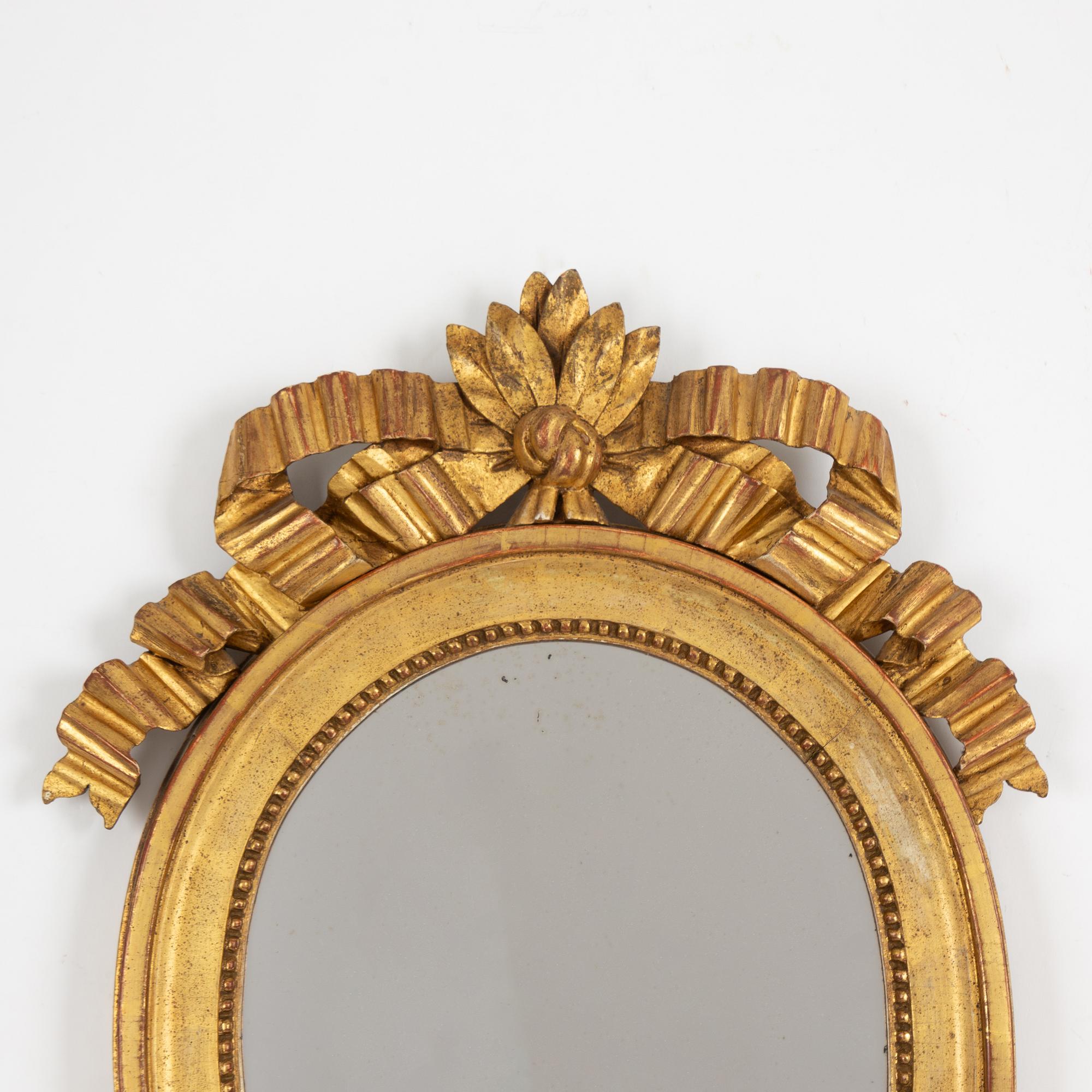 A pair of one-light Gustavian-style giltwood girandole mirrors, late 18th c /resp circa 1900.