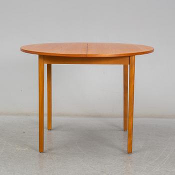 A second half of the 20th century teak veneered dining table.